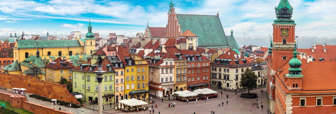 A view of the city of Warsaw filled with people during the day